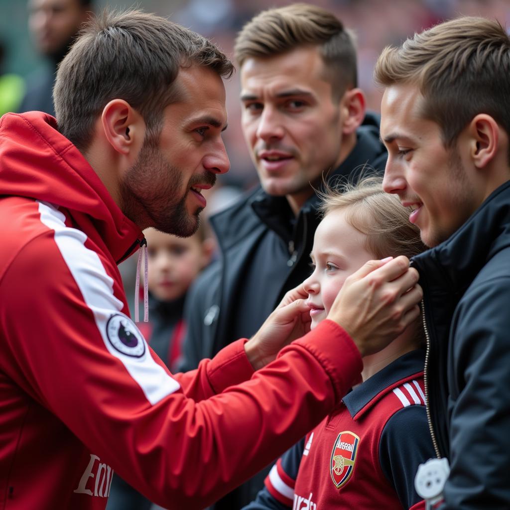 Arsenal player interacting with a young fan