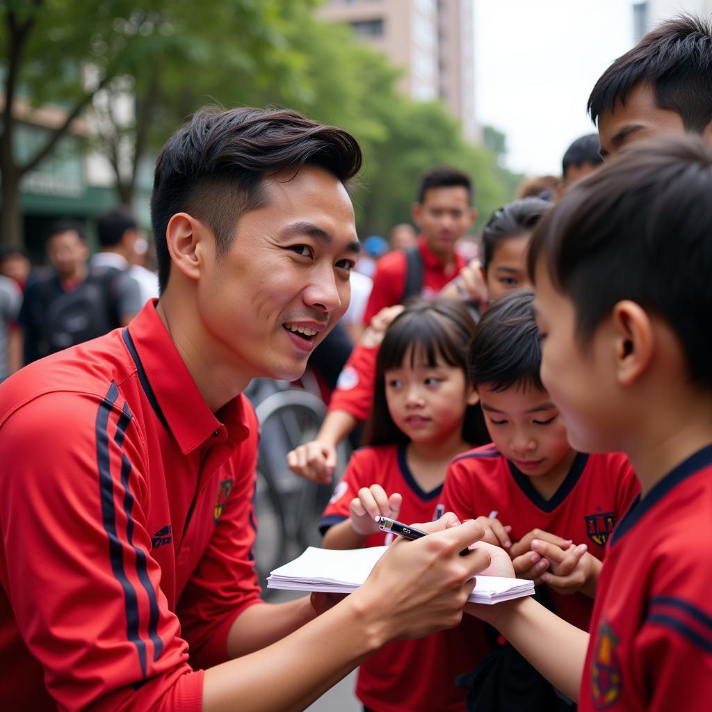  Bùi Tiến Dũng takes time to interact with young fans after a match.