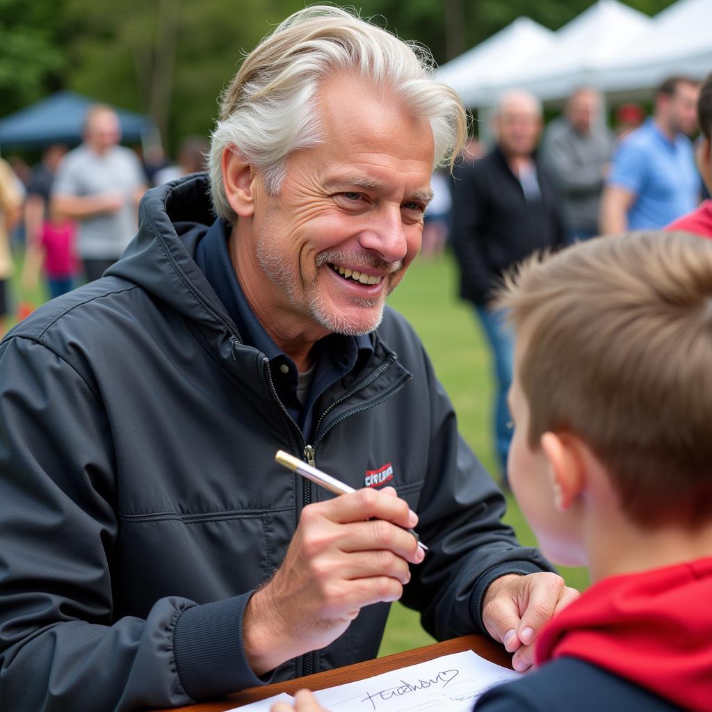 Erling Haaland signing an autograph for a young fan