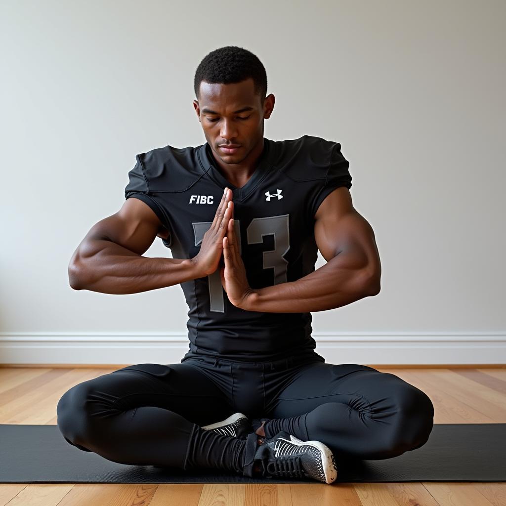 Football player performing back stretches