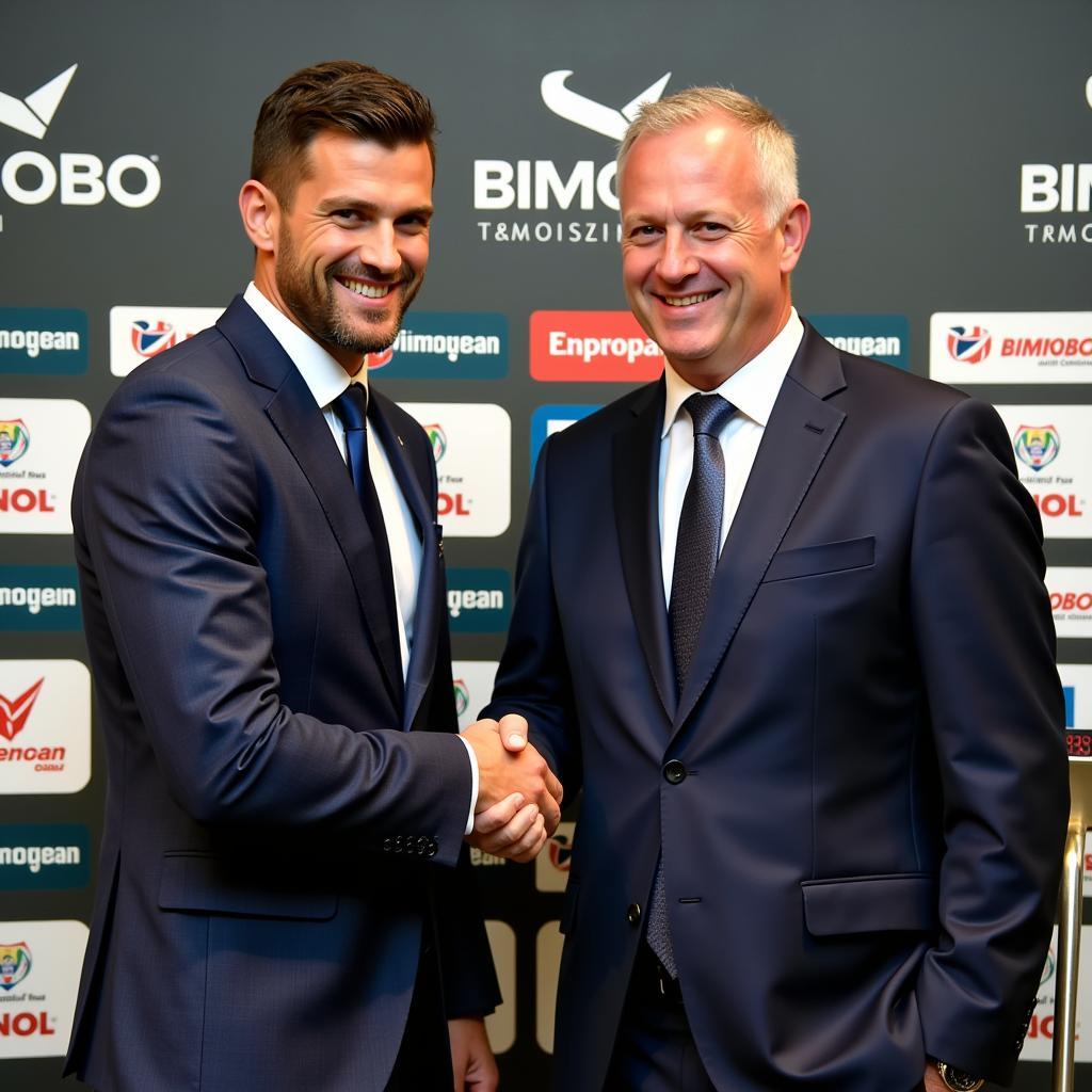 Footballer shaking hands with Bimobo representative