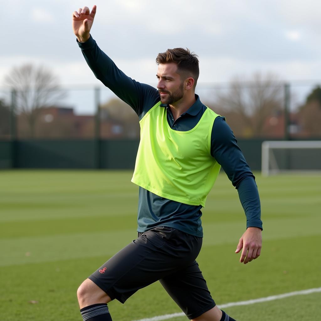 Footballer stretching pre-game in a base layer