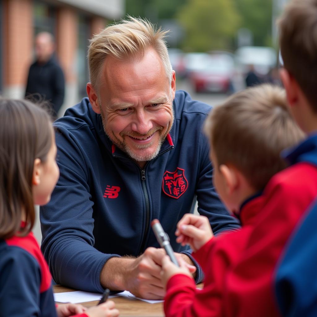 Erling Haaland interacts with young fans at a community event.