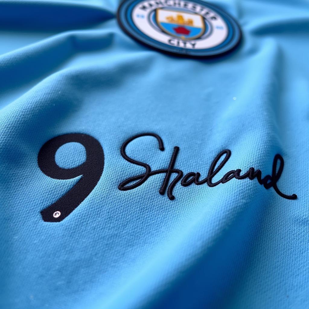 Close-up of Haaland's signature on a Manchester City jersey