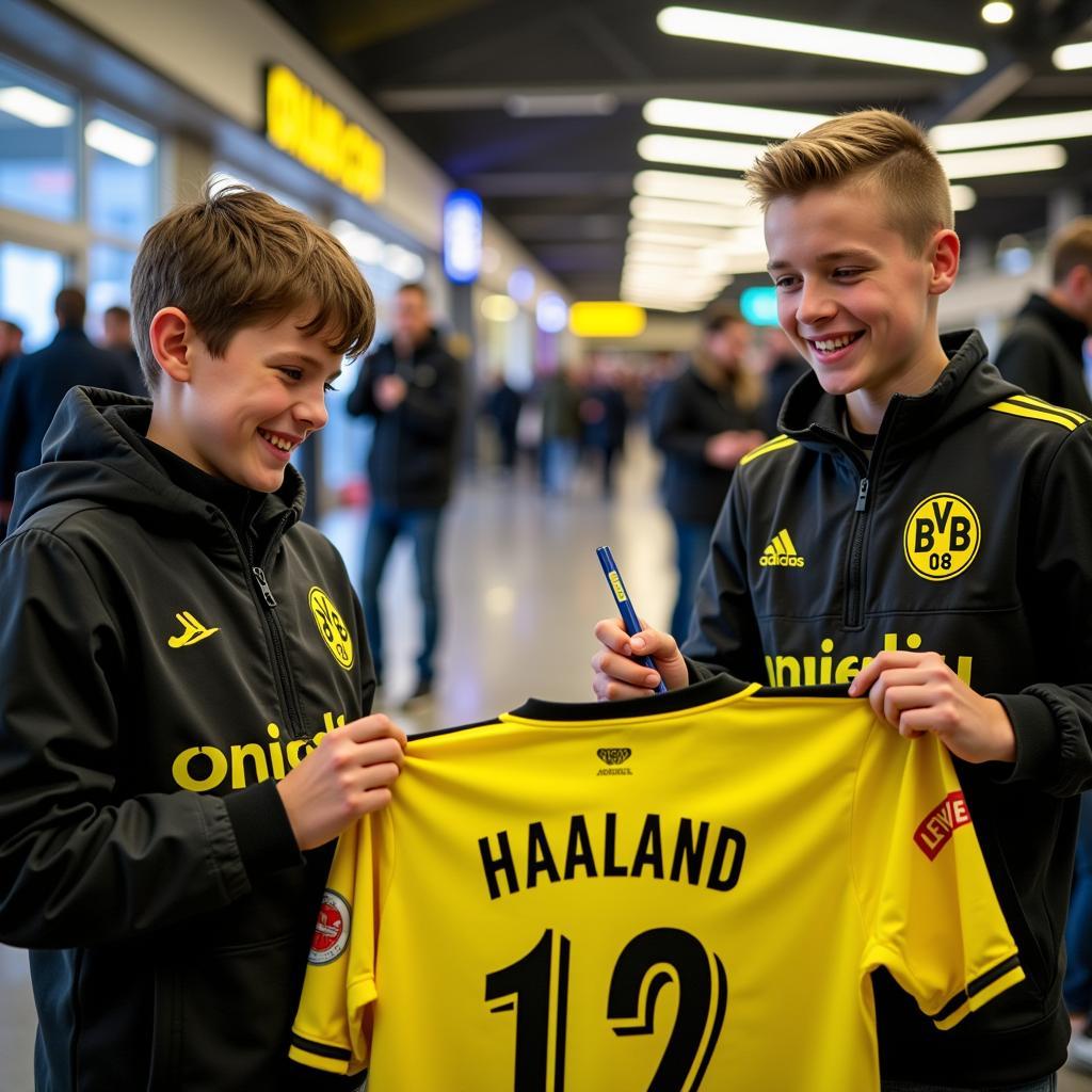 Erling Haaland signing a jersey for a young fan