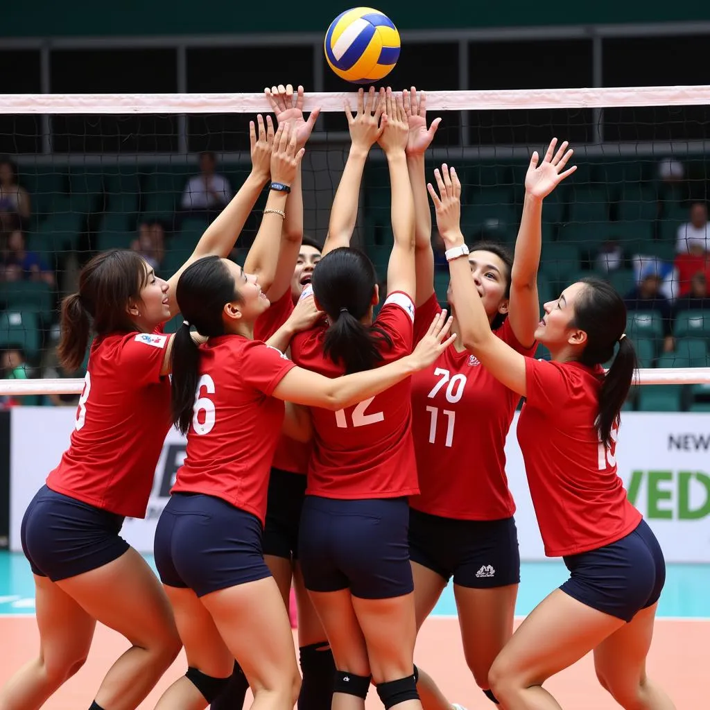 Vietnamese volleyball players form a strong block at the net