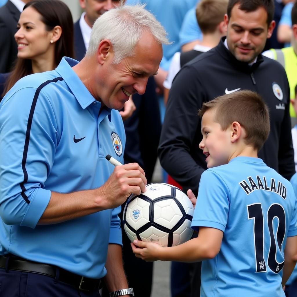 Erling Haaland signing a football for a fan