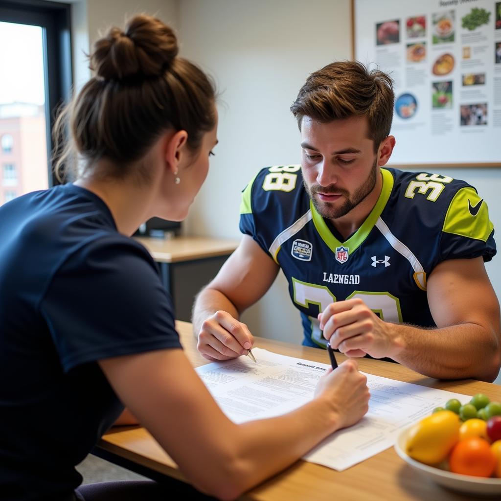 A football player discussing his diet plan with a registered nutritionist.