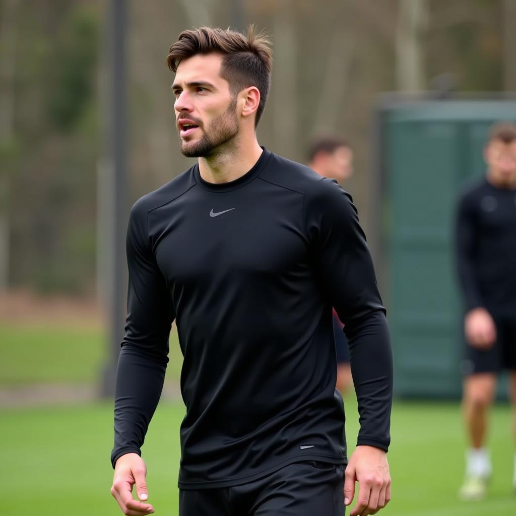 Footballer wearing a base layer under his jersey