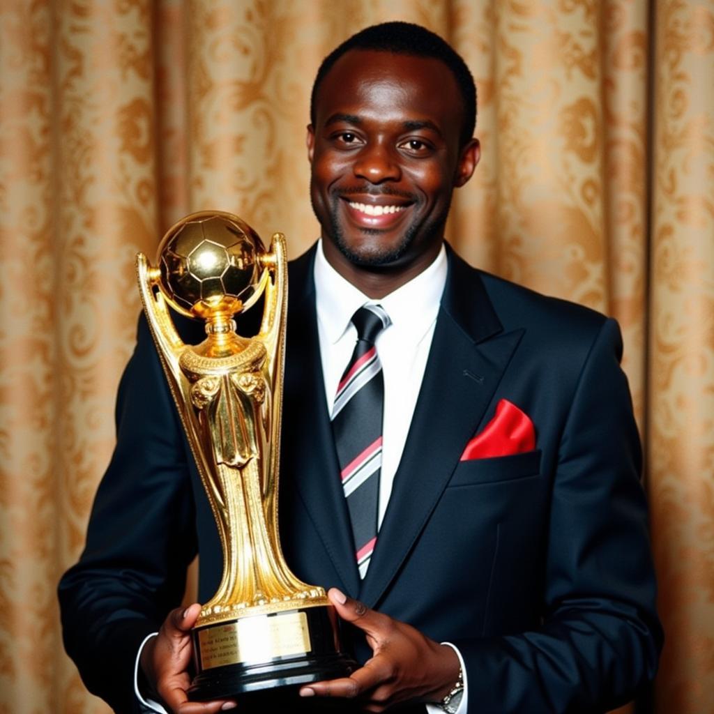 George Weah holding the prestigious Ballon d'Or trophy, a testament to his exceptional footballing talent.