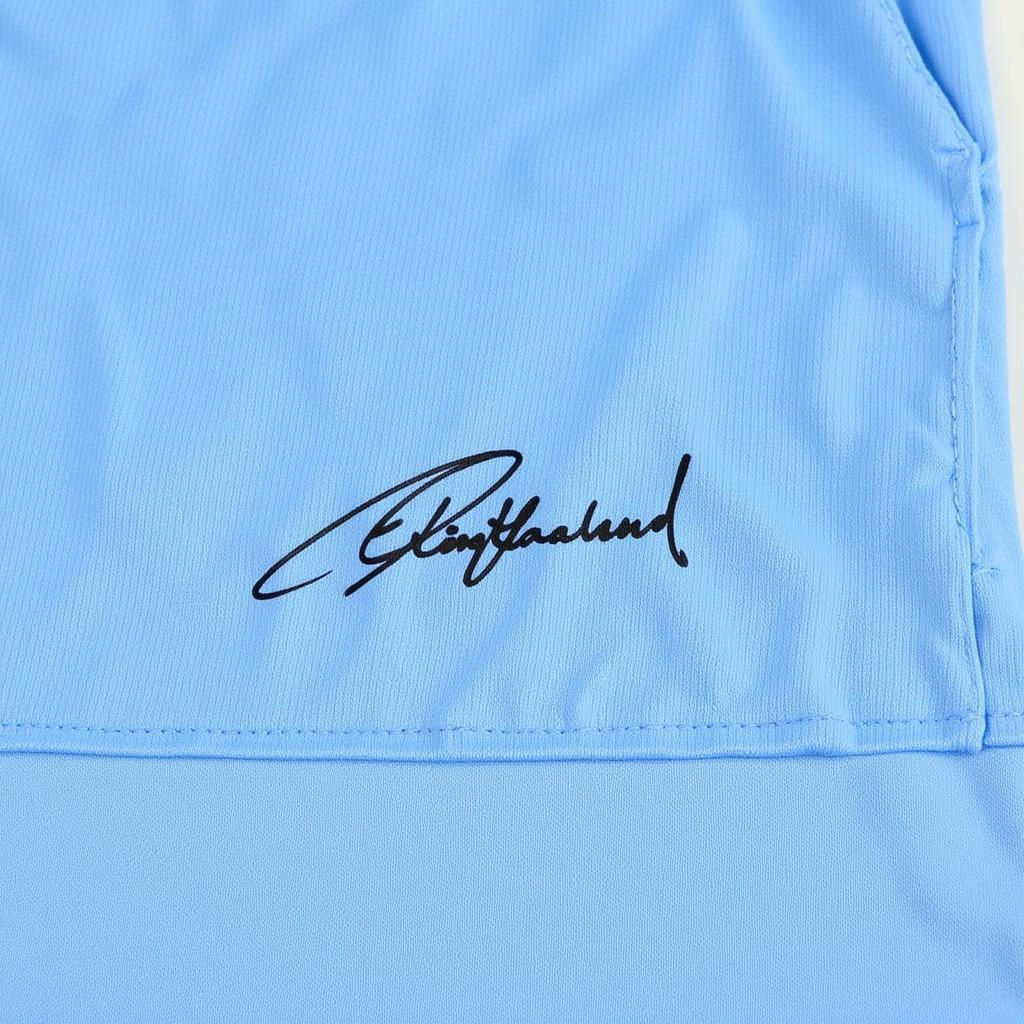 Closeup of Erling Haaland's signature on a Manchester City jersey