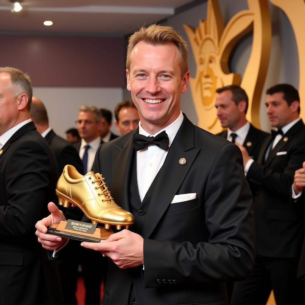 Erling Haaland holding a top scorer award