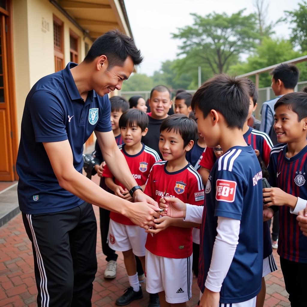 Nguyen Duy Manh interacting with young football fans.