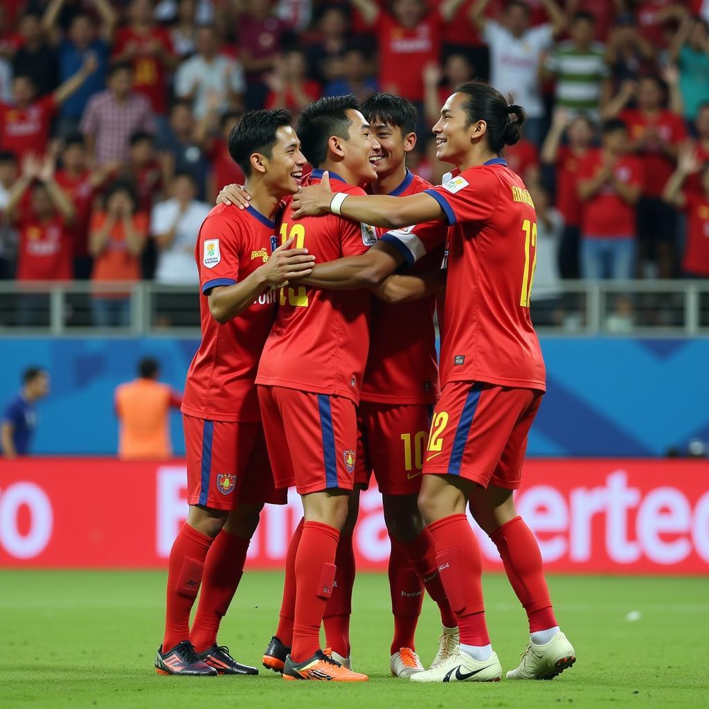 Chanvanaka celebrating a goal with his teammates, showcasing the joy and camaraderie in Cambodian football.