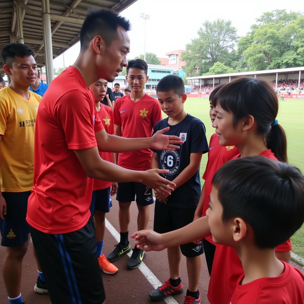 Do Duy Manh interacting with young football enthusiasts