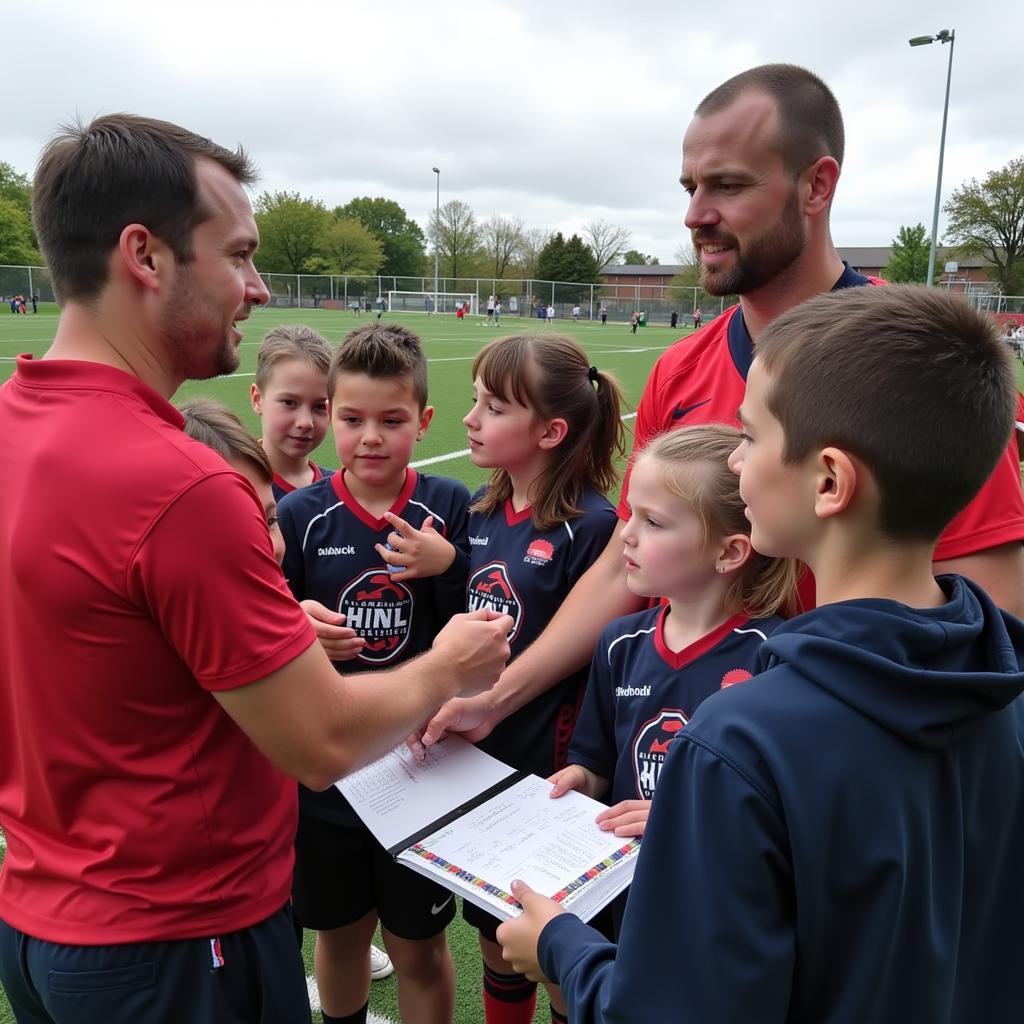 Erling Haaland interacting with young fans at a football training camp.