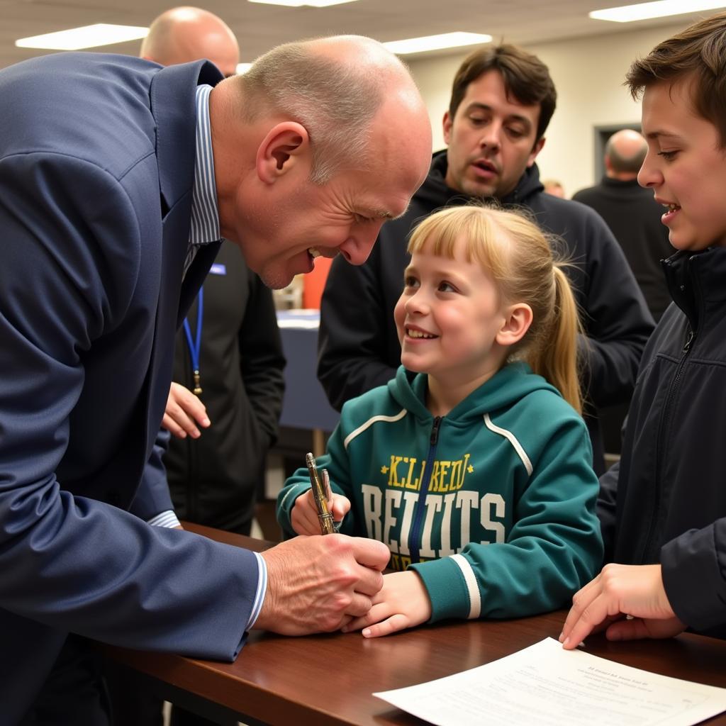 Erling Haaland interacting with a young fan, signing an autograph