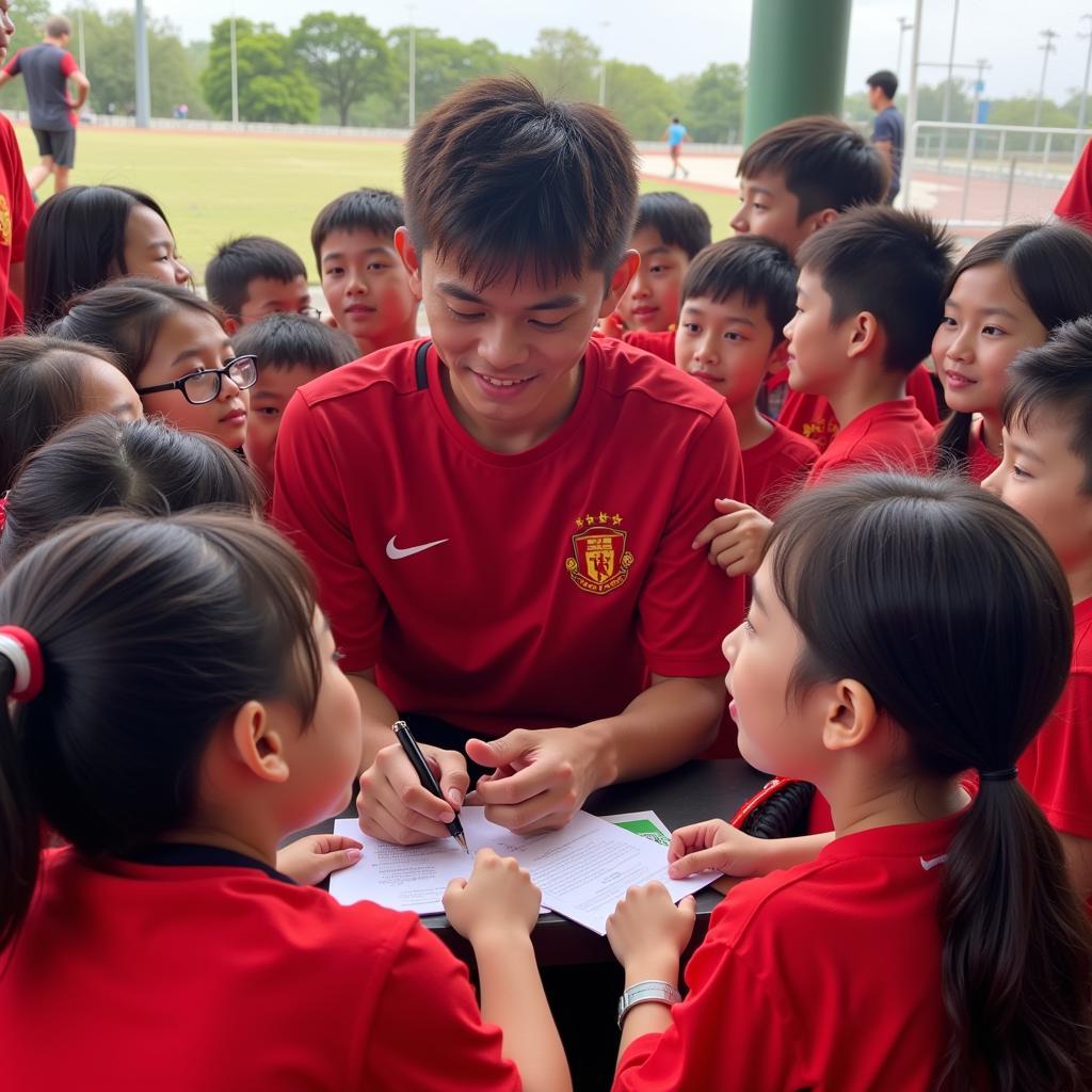 Tran Minh Chien signing autographs for young fans, highlighting his role as a role model.