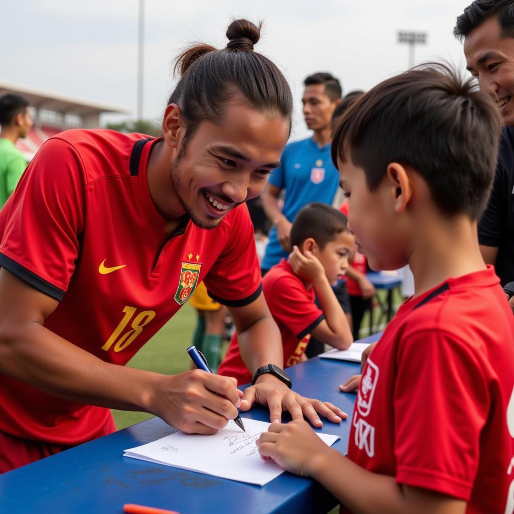 U23 Vietnam player signing an autograph for a young fan