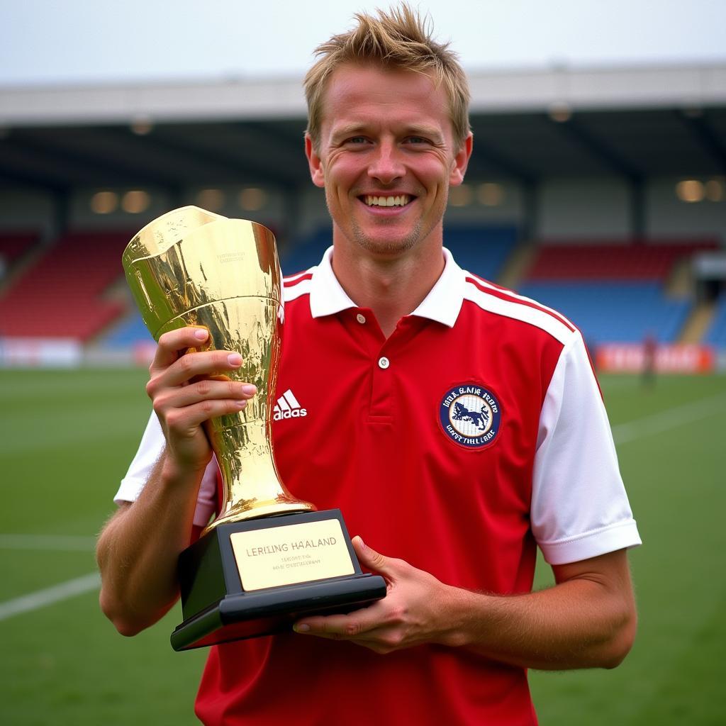 Erling Haaland holding the Golden Boot award.